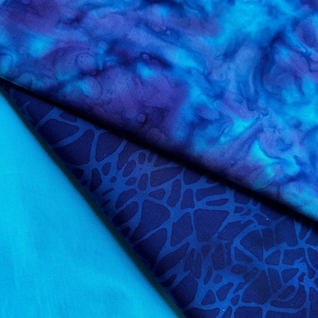 Branch-Blue, Tanzanite, and Turquoise Solid Batik are the fabrics I choose for Larry Lyon